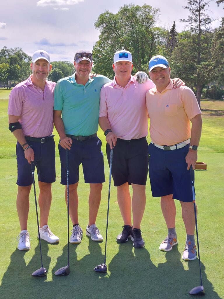 Golf Scramble participants pose for a photo