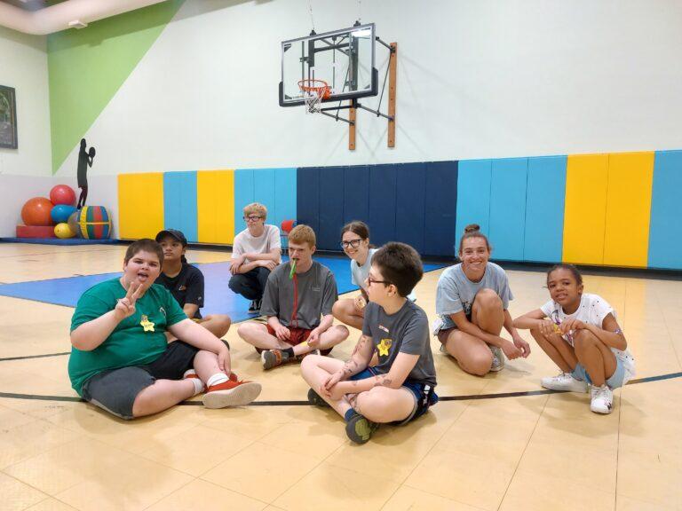 Children sitting on a gym floor